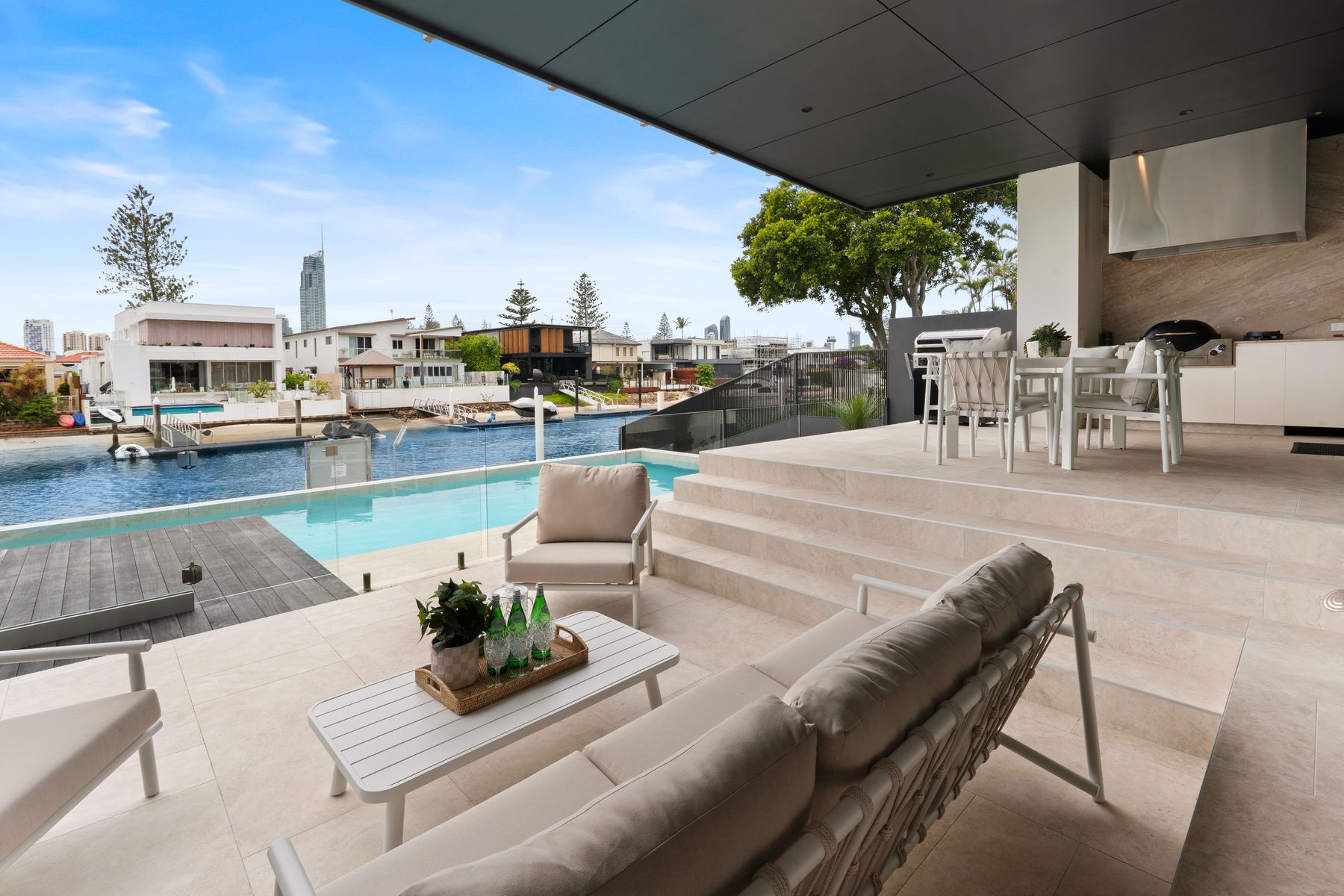 Alfresco lounge stepping down to the pool and canal